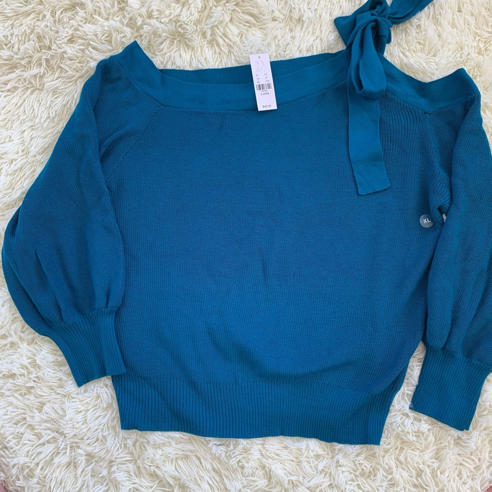 A one shoulder New York New York sweater.